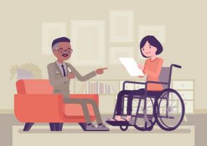 a social security disability attorney talking to a disabled woman sitting on a wheelchair while reading a document