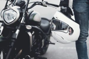 motorcycle driver holding a helmet