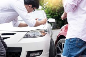 Man taking picture of the car accident scene